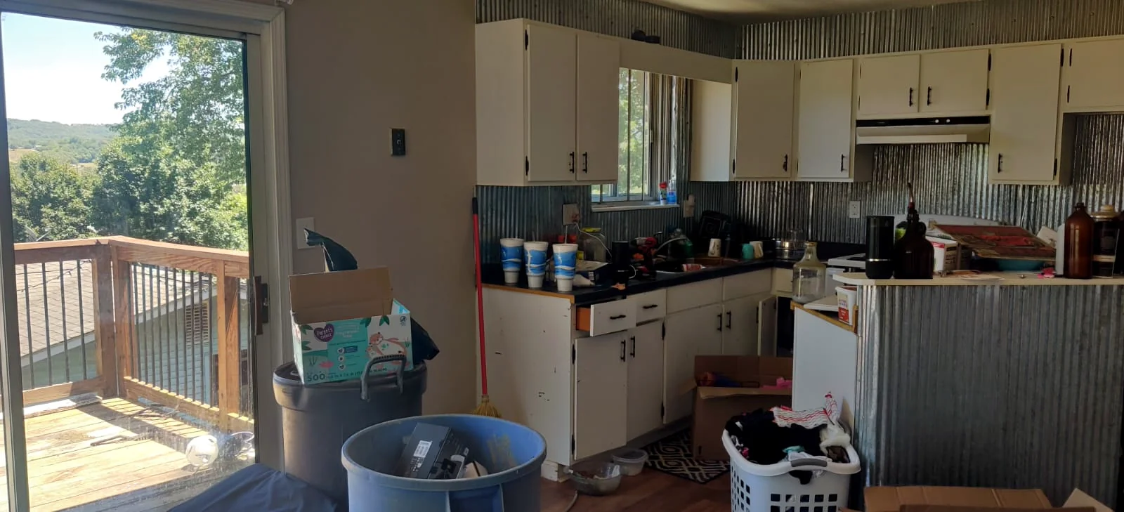 Before renovation: older kitchen with white cabinets